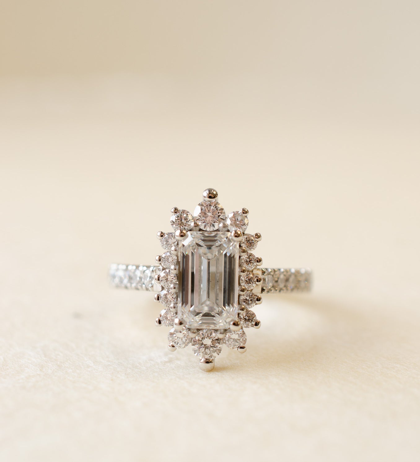 Emerald Cut Diamond Cluster Ring With Graduated Halo