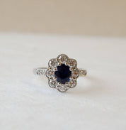 Oval cut blue sapphire and diamond cluster ring