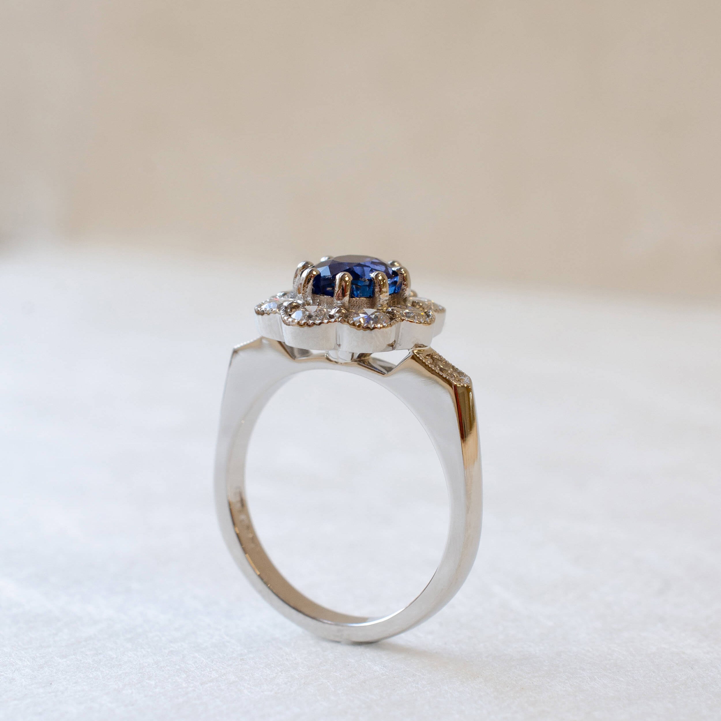 platinum blue sapphire cluster ring with diamonds