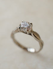 platinum solitaire engagement ring with twist shoulders