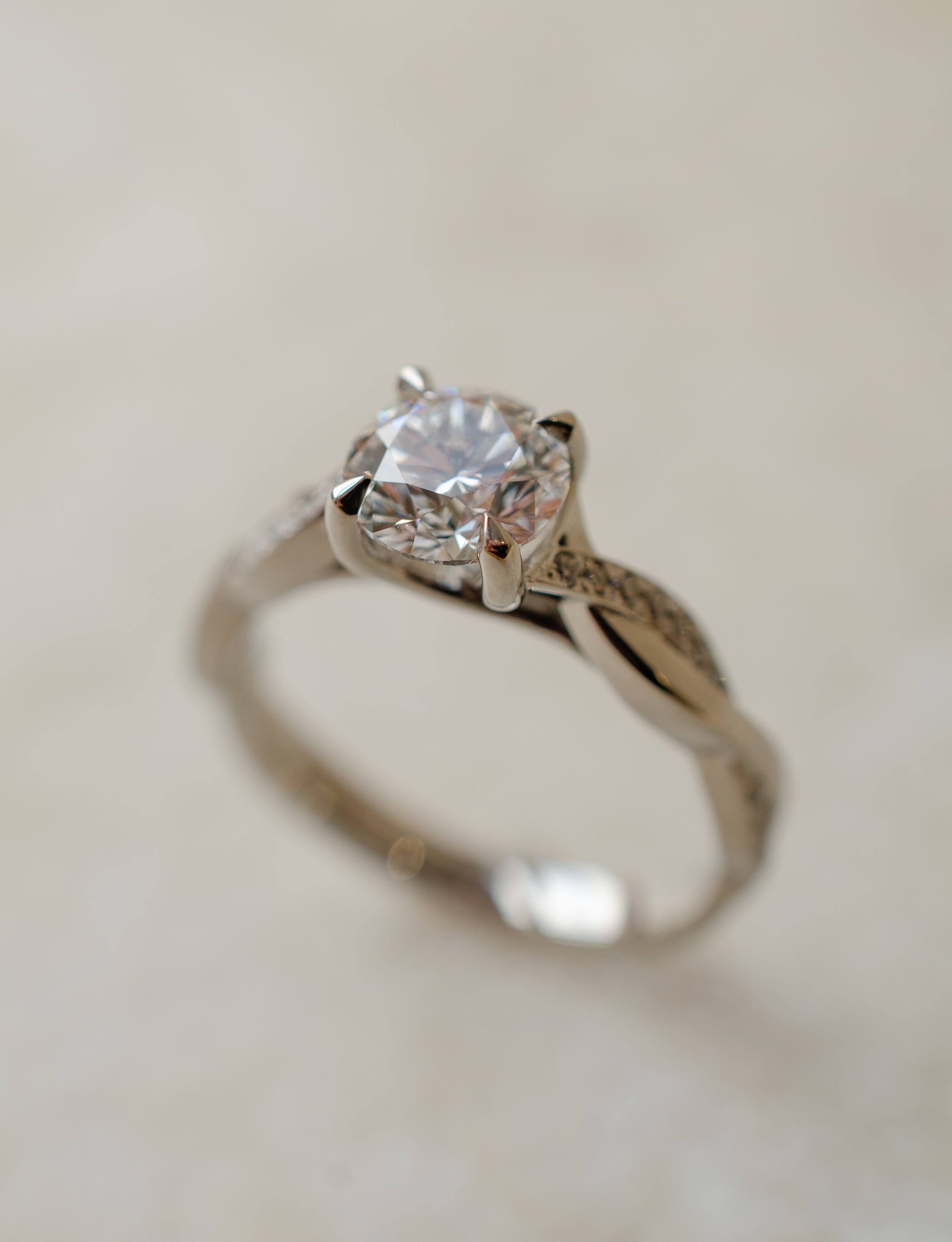 platinum solitaire engagement ring with twist shoulders