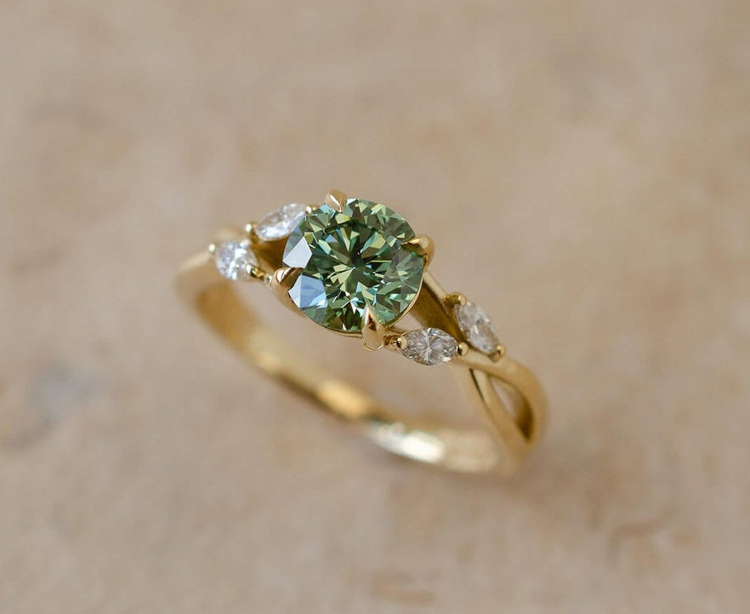 Yellow gold vine inspired engagement ring with green diamond centre stone