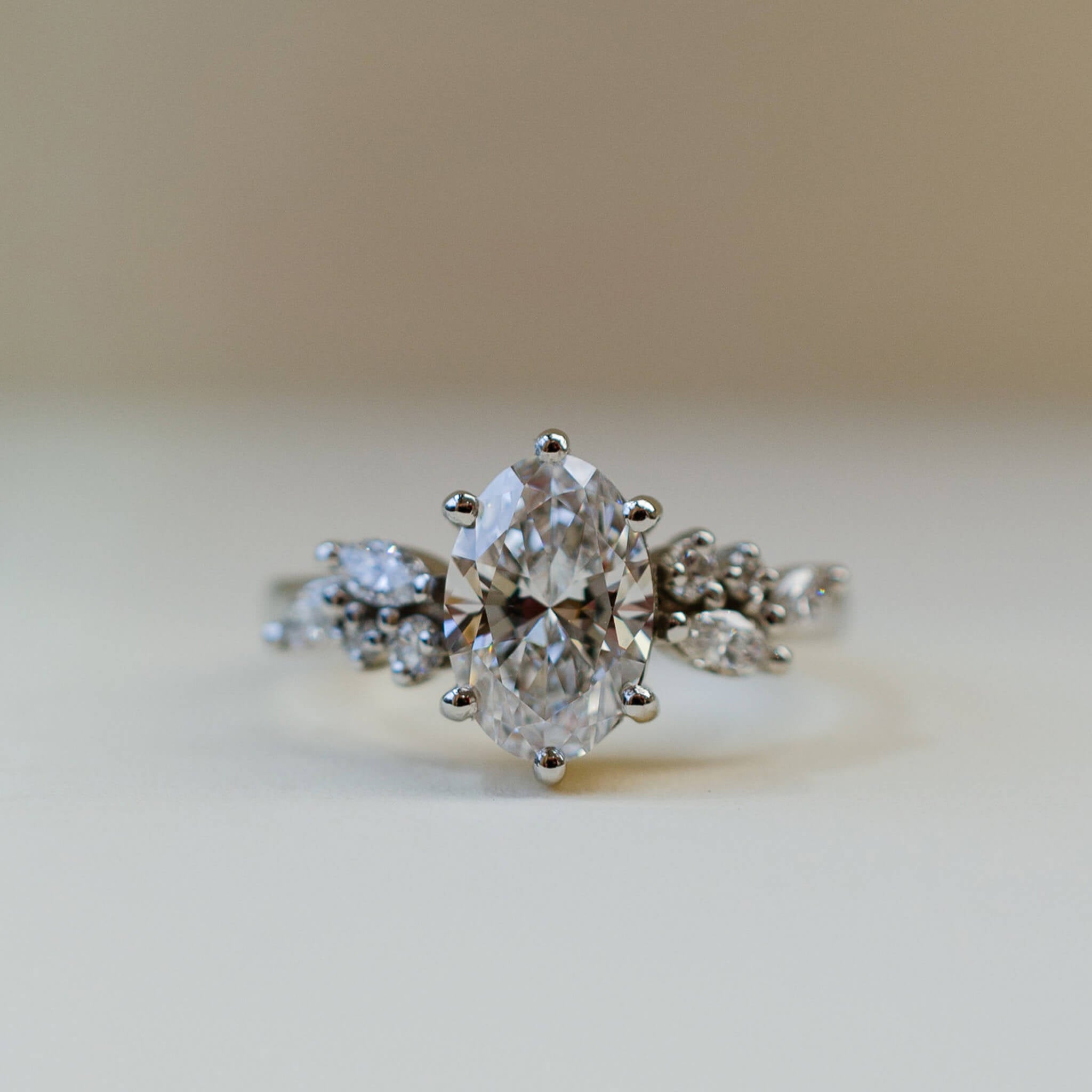 oval diamond scatter shoulder ring in platinum