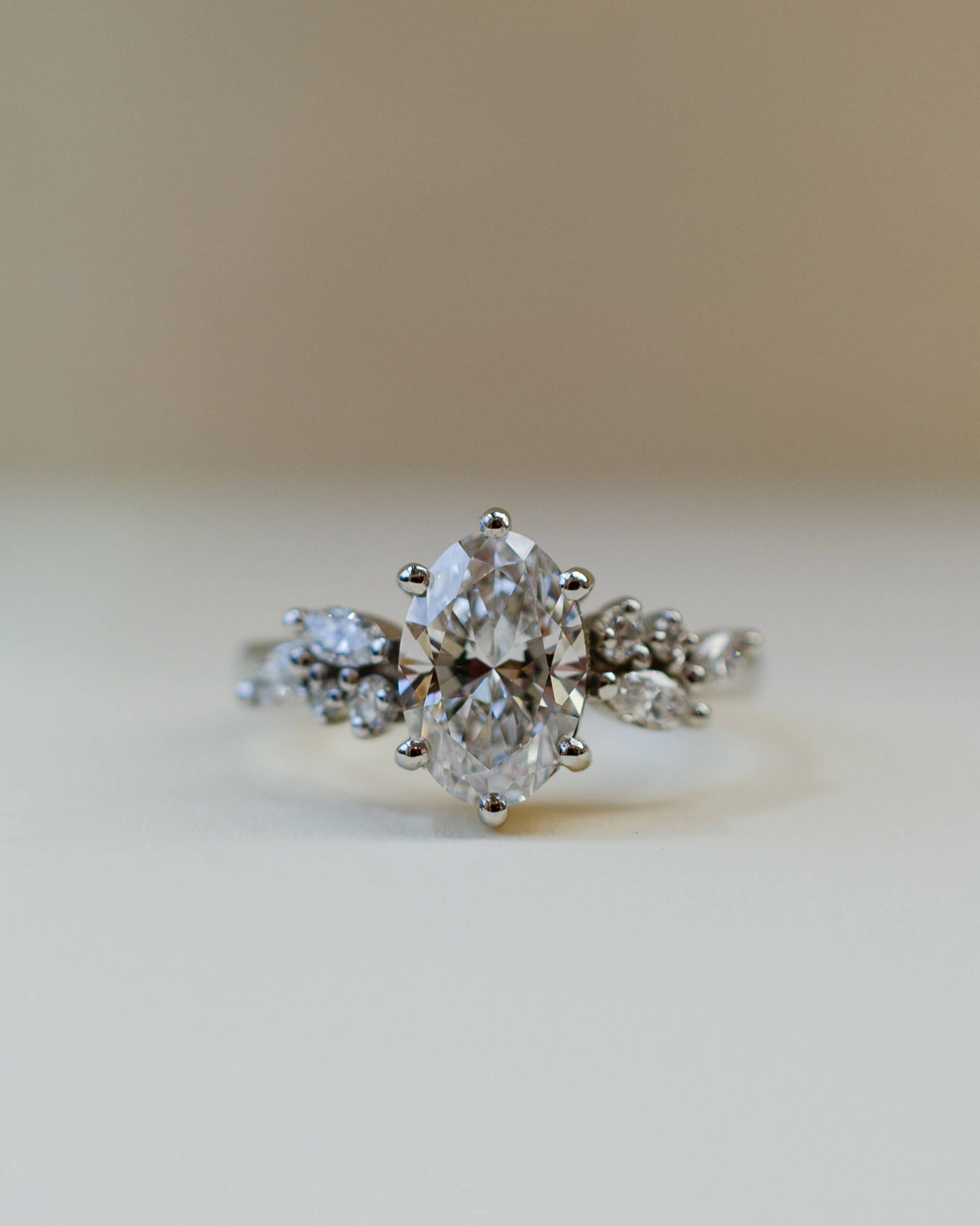 oval diamond scatter shoulder ring in platinum