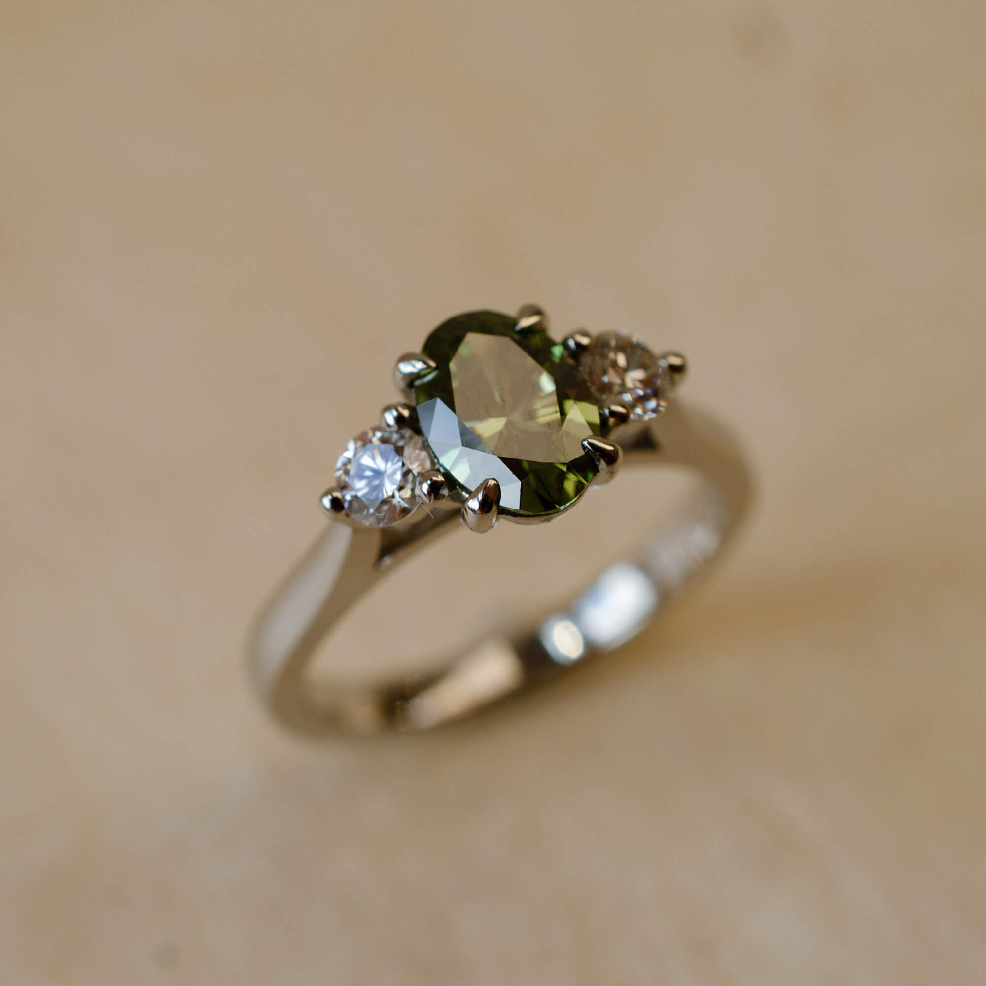 Lab grown green diamond trilogy ring in platinum