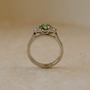 three stone ring with green lab-grown diamond and white diamonds
