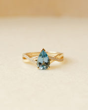yellow gold ring with pear cut aquamarine and twist shoulders set with diamonds 