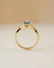 yellow gold ring with pear cut aquamarine and twist shoulders set with diamonds 