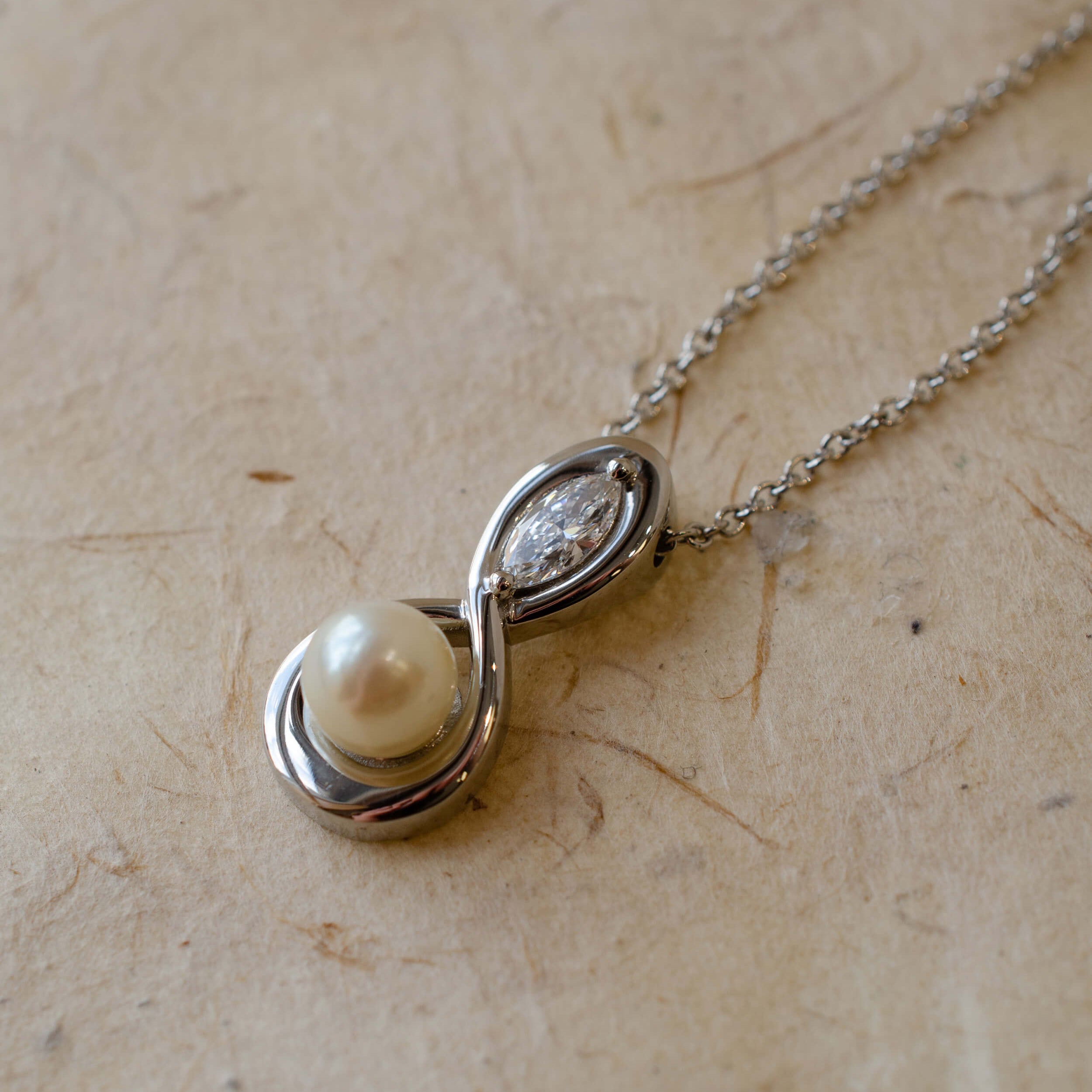 marquise diamond and pearl infinity inspired pendant in platinum