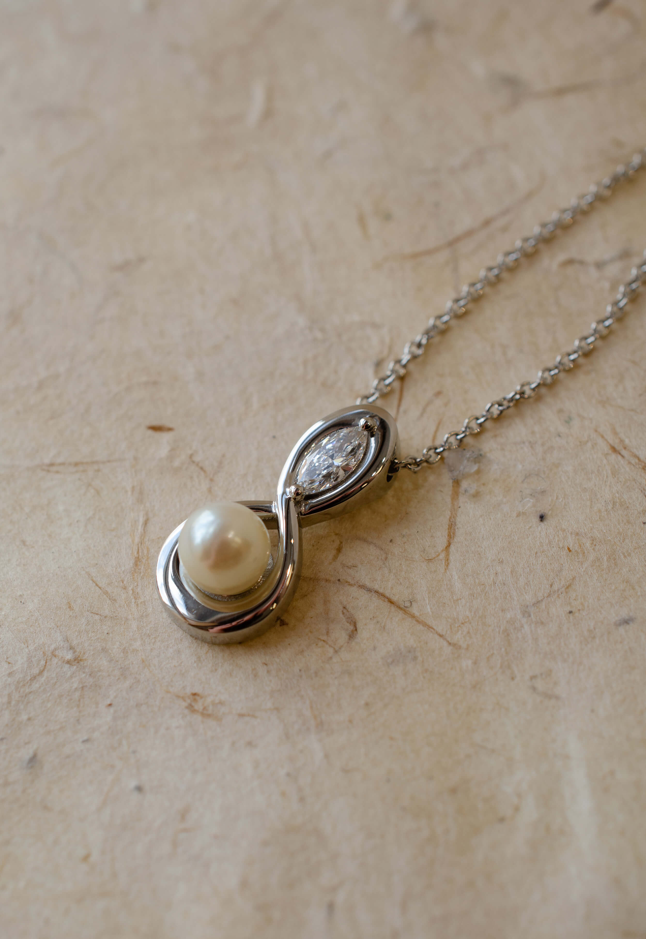 marquise diamond and pearl infinity inspired pendant in platinum
