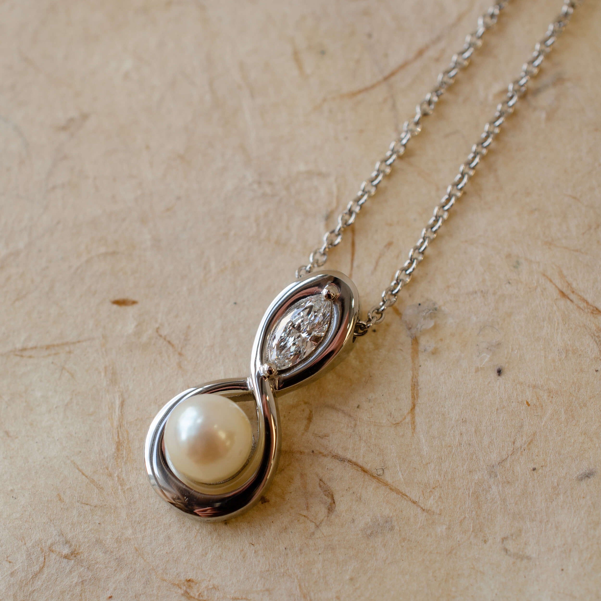 Infinity inspired pendant with pearl and diamond