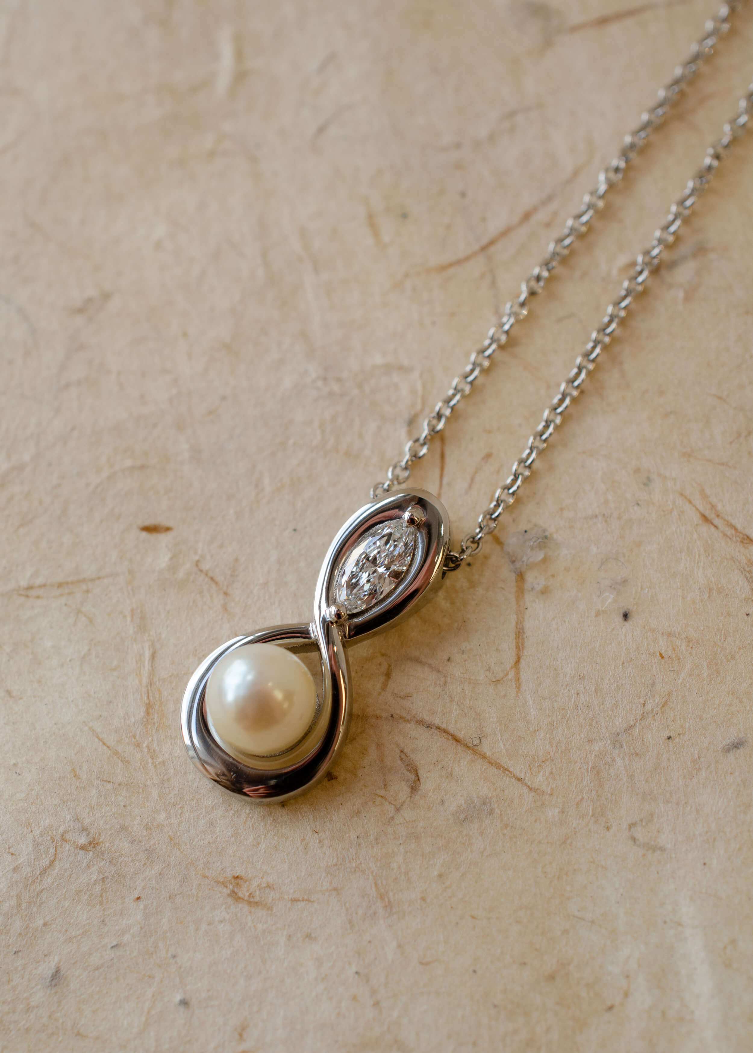 Infinity inspired pendant with pearl and diamond
