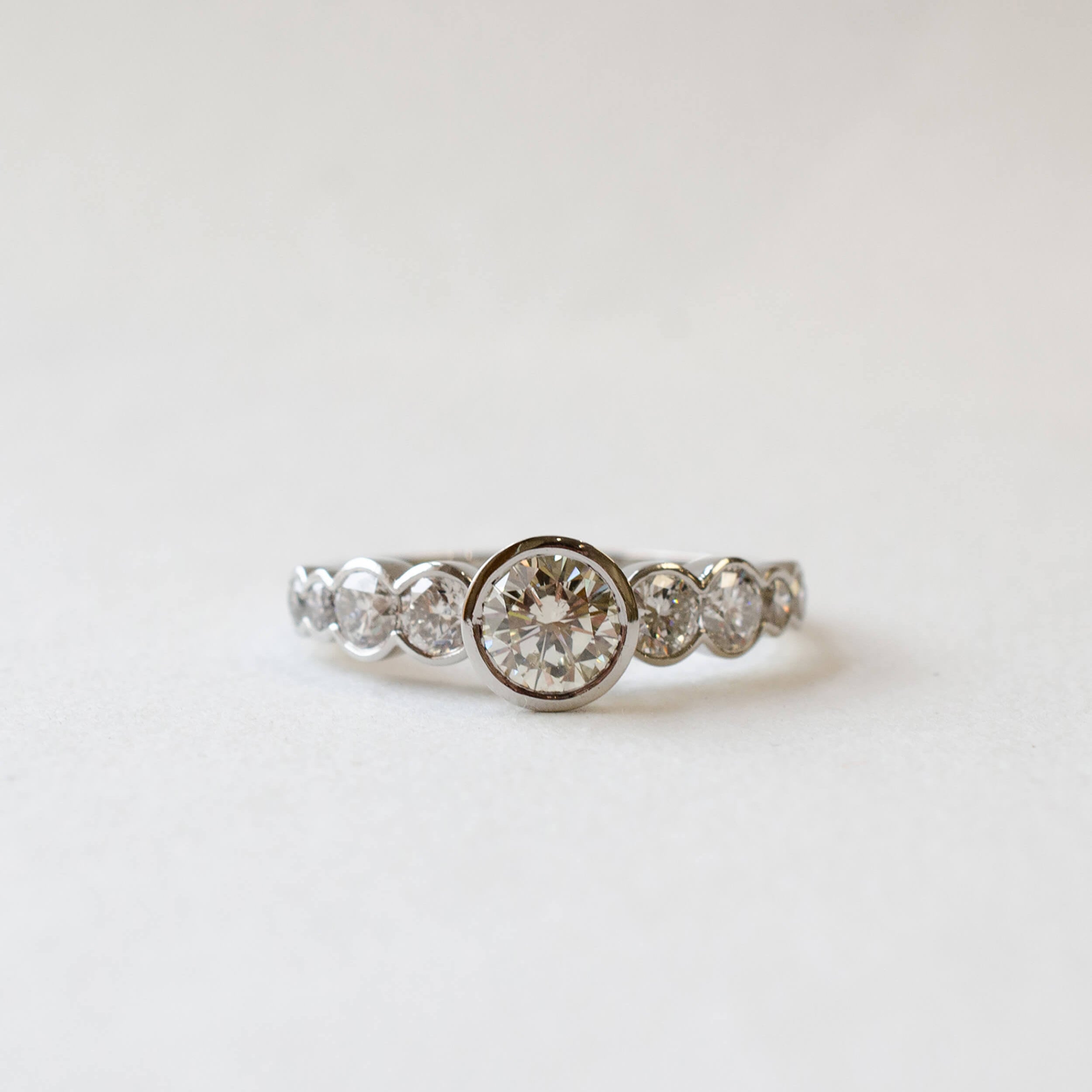 Platinum nine diamond rub-set engagement ring 