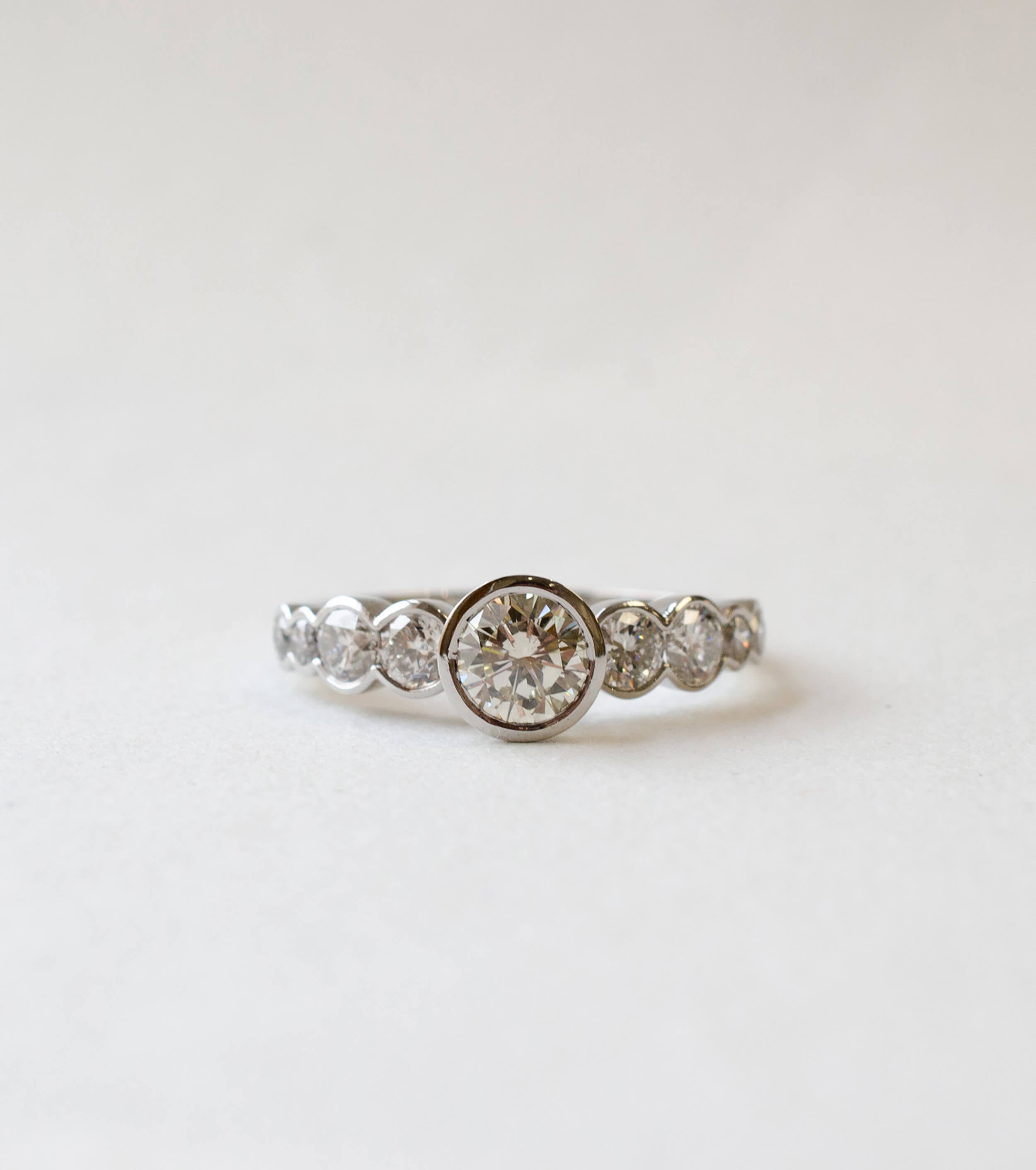 Platinum nine diamond rub-set engagement ring 