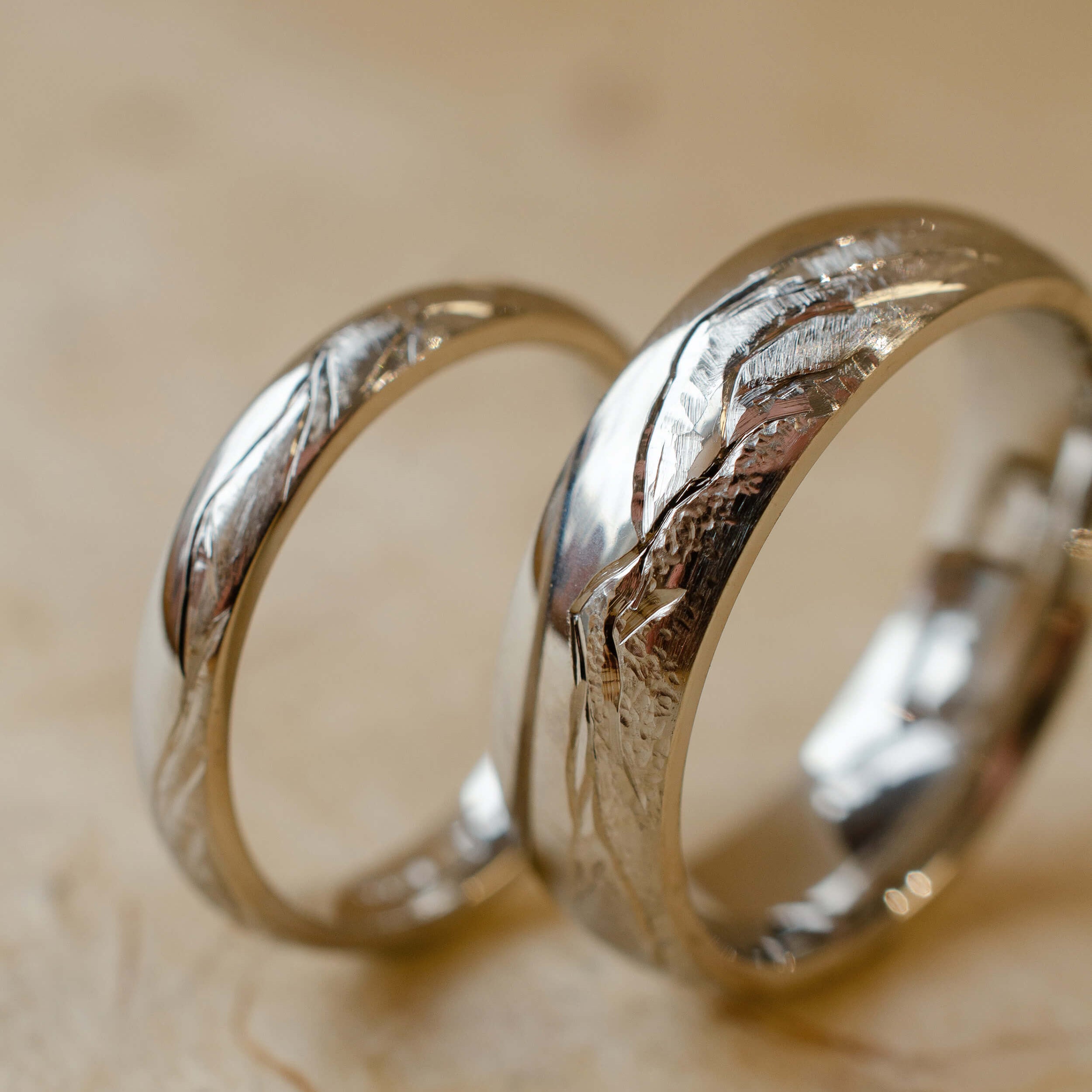 matching wedding bands with hand engraved mountainscape