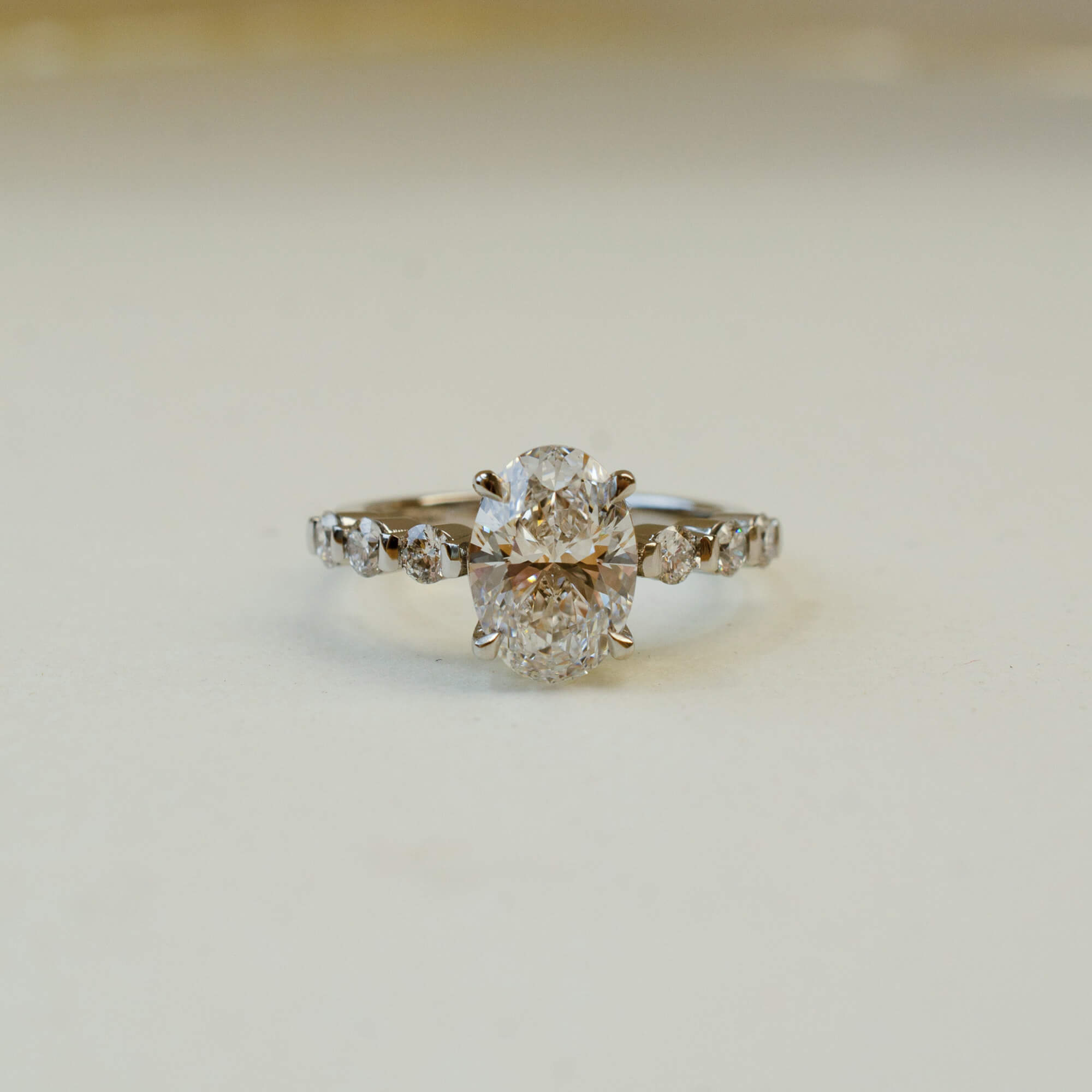 oval cut diamond engagement ring with diamond set shoulders