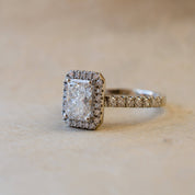 halo engagement ring with radiant cut diamond 