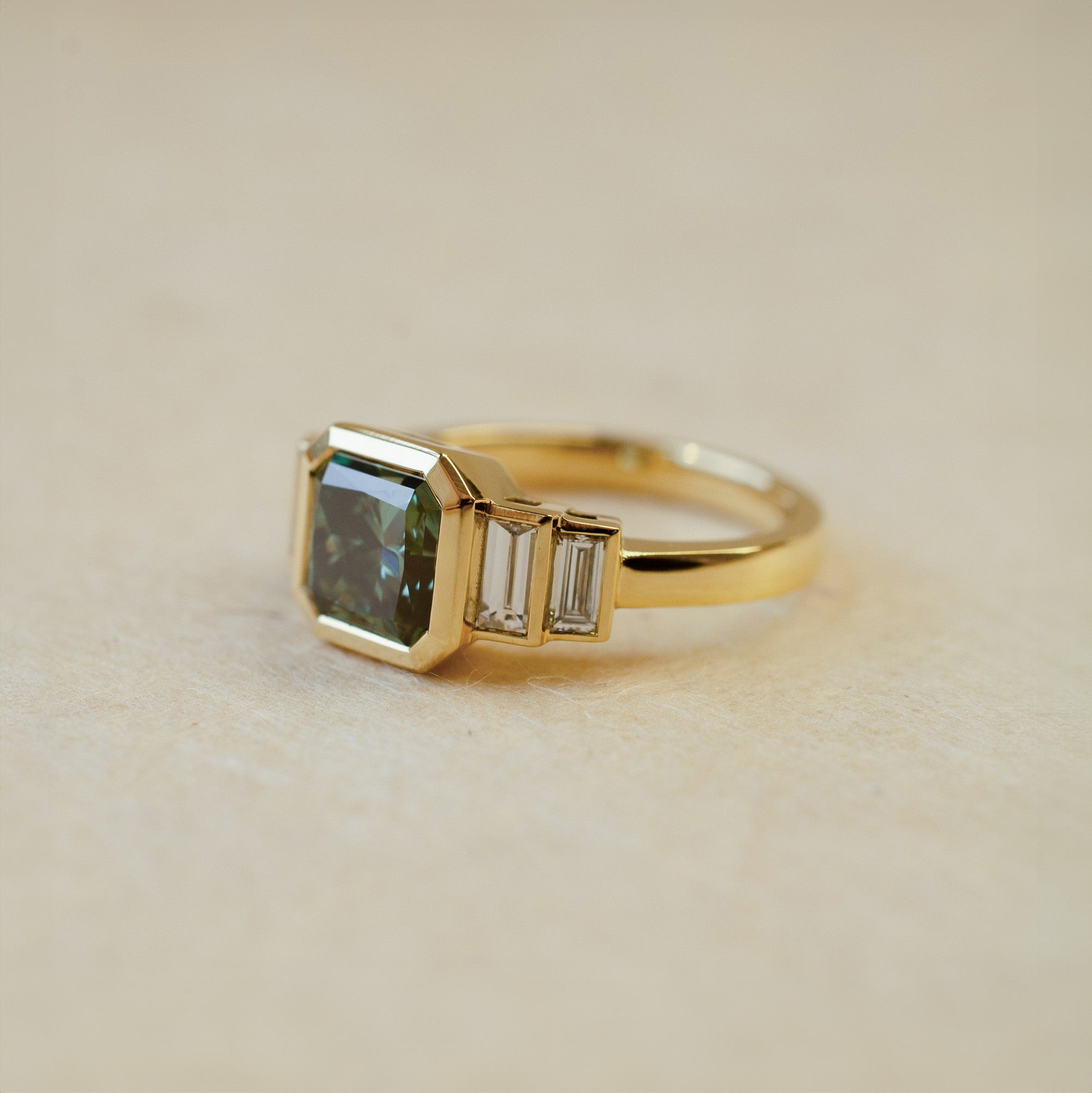 teal lab diamond engagement ring with baguette cut side stones