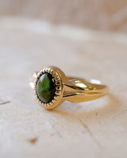 yellow gold alternative engagement ring with tourmaline cabochon