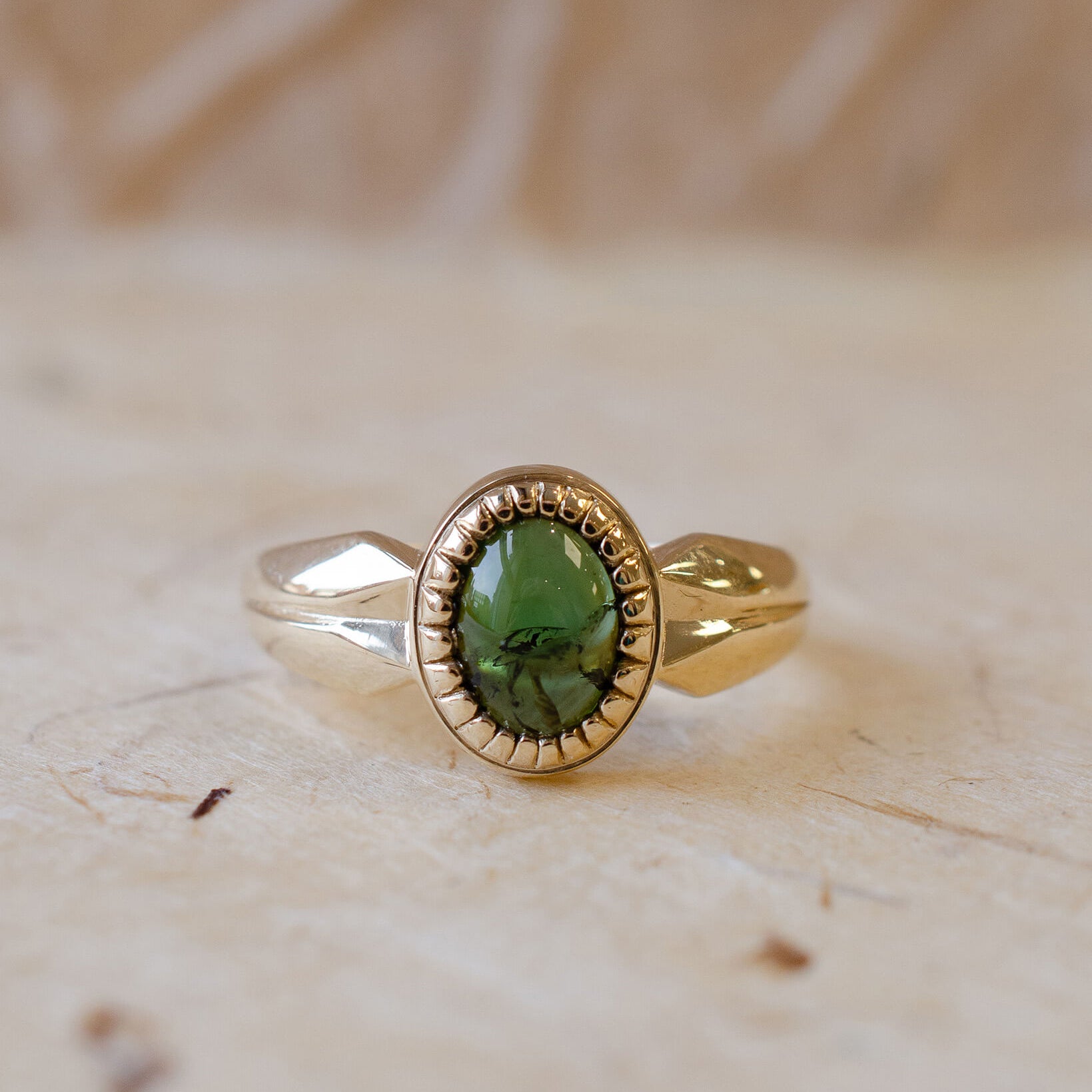 yellow gold alternative engagement ring with tourmaline cabochon