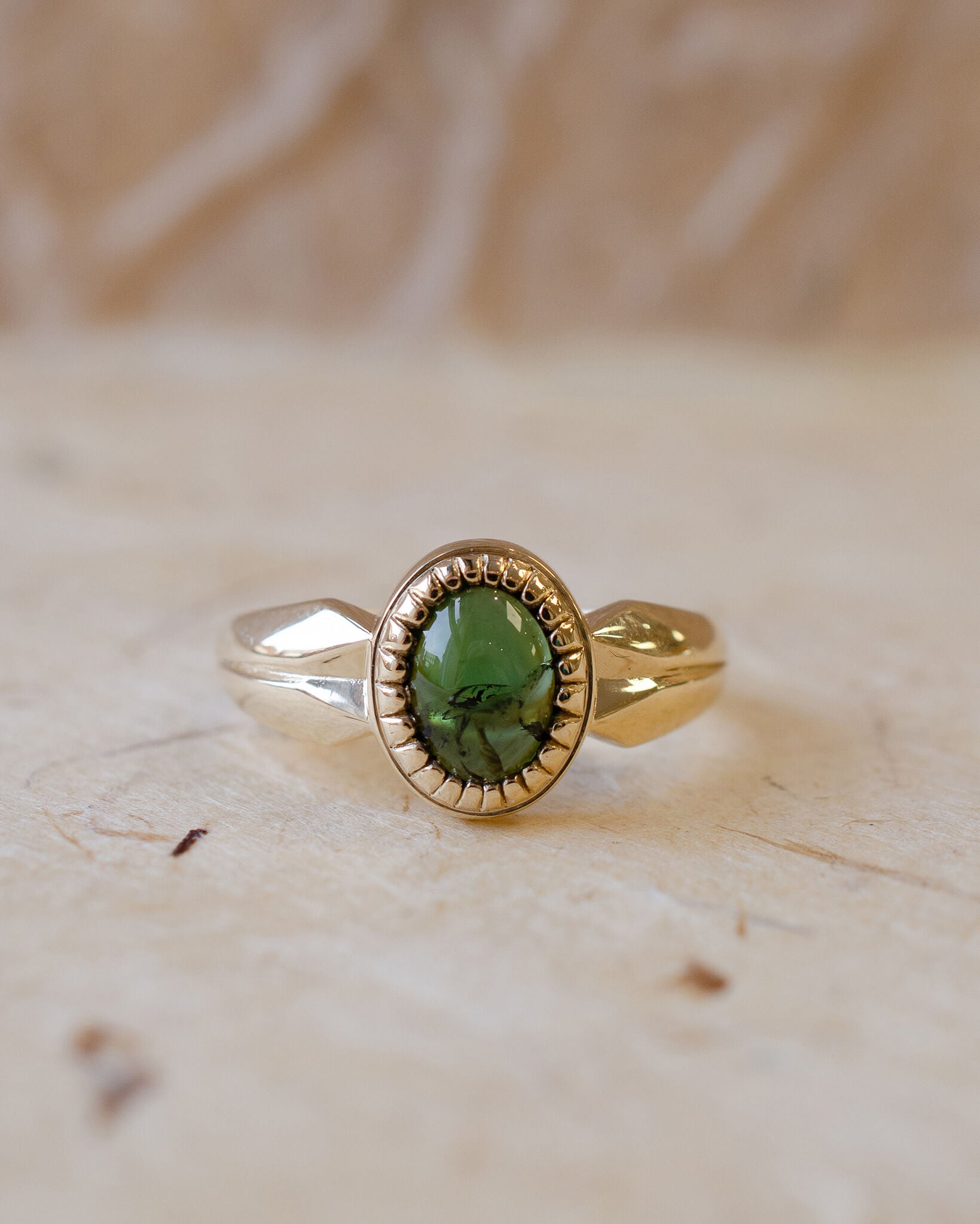 yellow gold alternative engagement ring with tourmaline cabochon