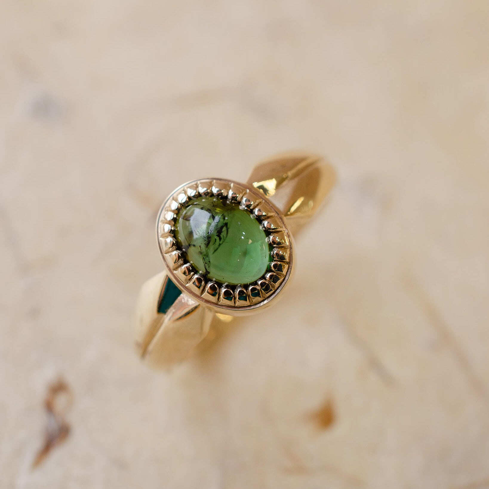 yellow gold alternative engagement ring with tourmaline cabochon