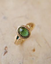 yellow gold alternative engagement ring with tourmaline cabochon