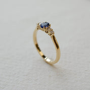 yellow gold five stone engagement ring with sapphire and diamonds
