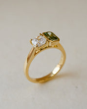 A two stone engagement ring with a white and a green lab-grown diamond