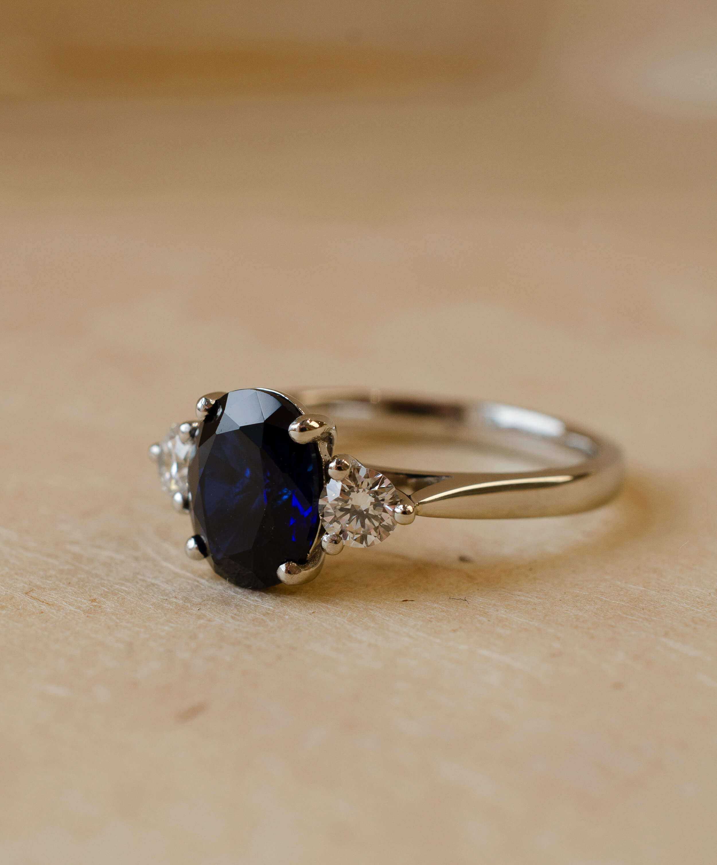 oval cut blue sapphire and diamond trilogy ring in platinum