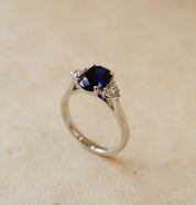 oval cut blue sapphire and round diamond trilogy ring in platinum
