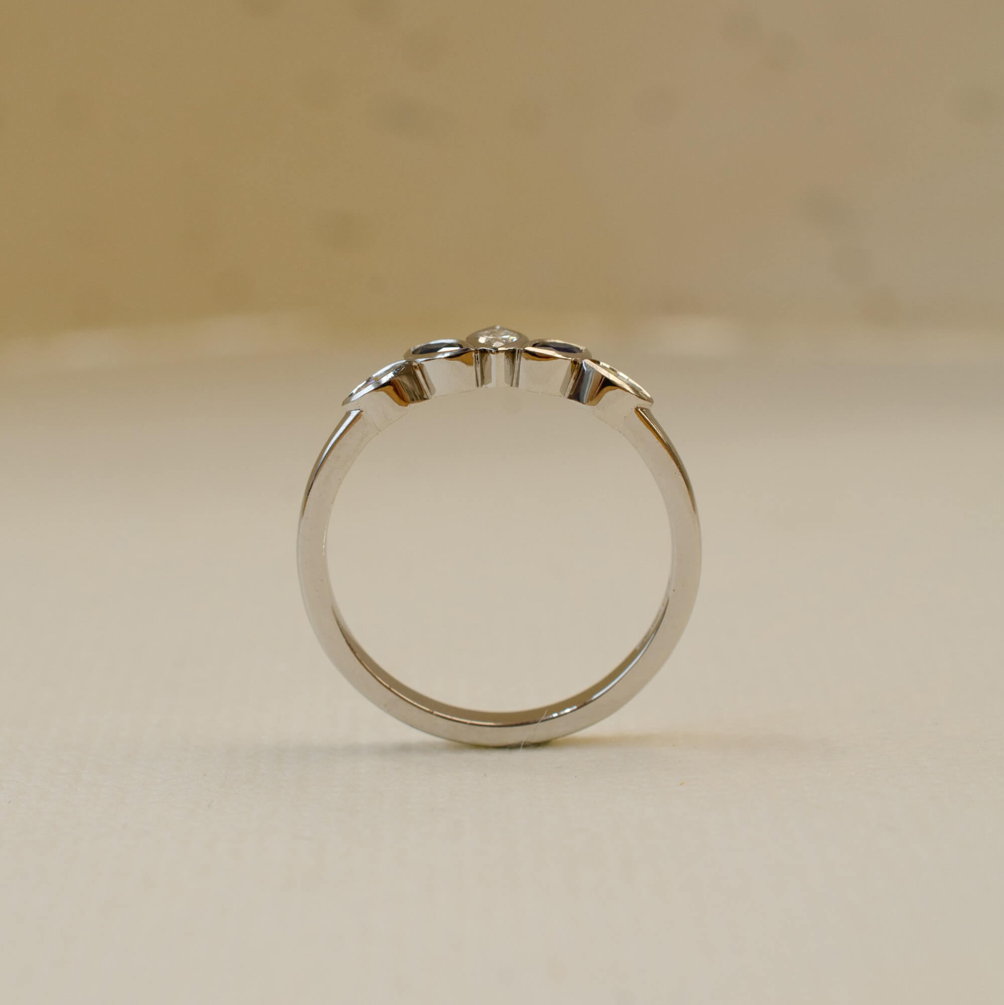 platinum shaped wedding ring with marquise diamonds and sapphires 