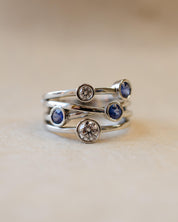 A platinum bubble ring with white diamonds and blue sapphires