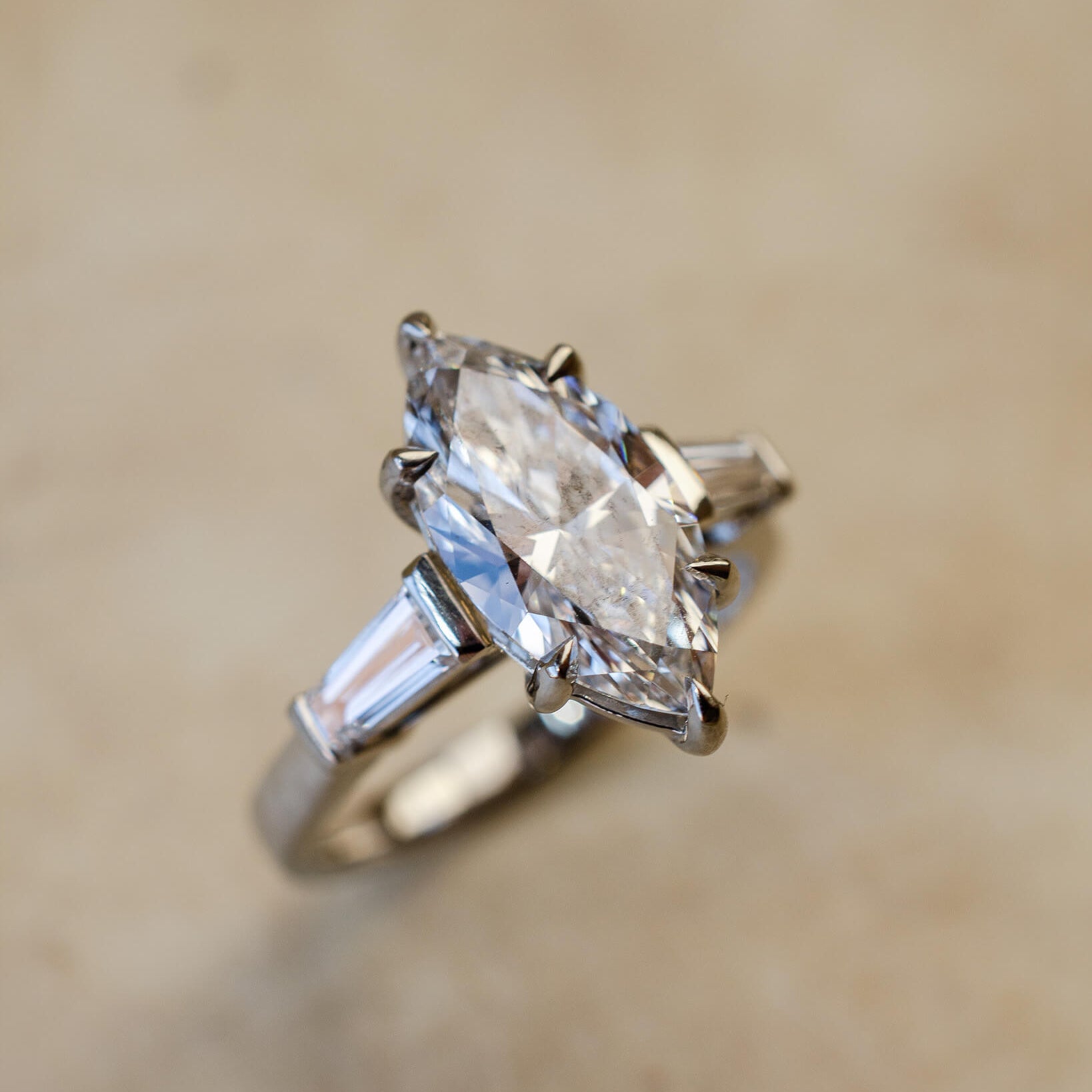 platinum diamond engagement ring with marquise and tapered baguettes