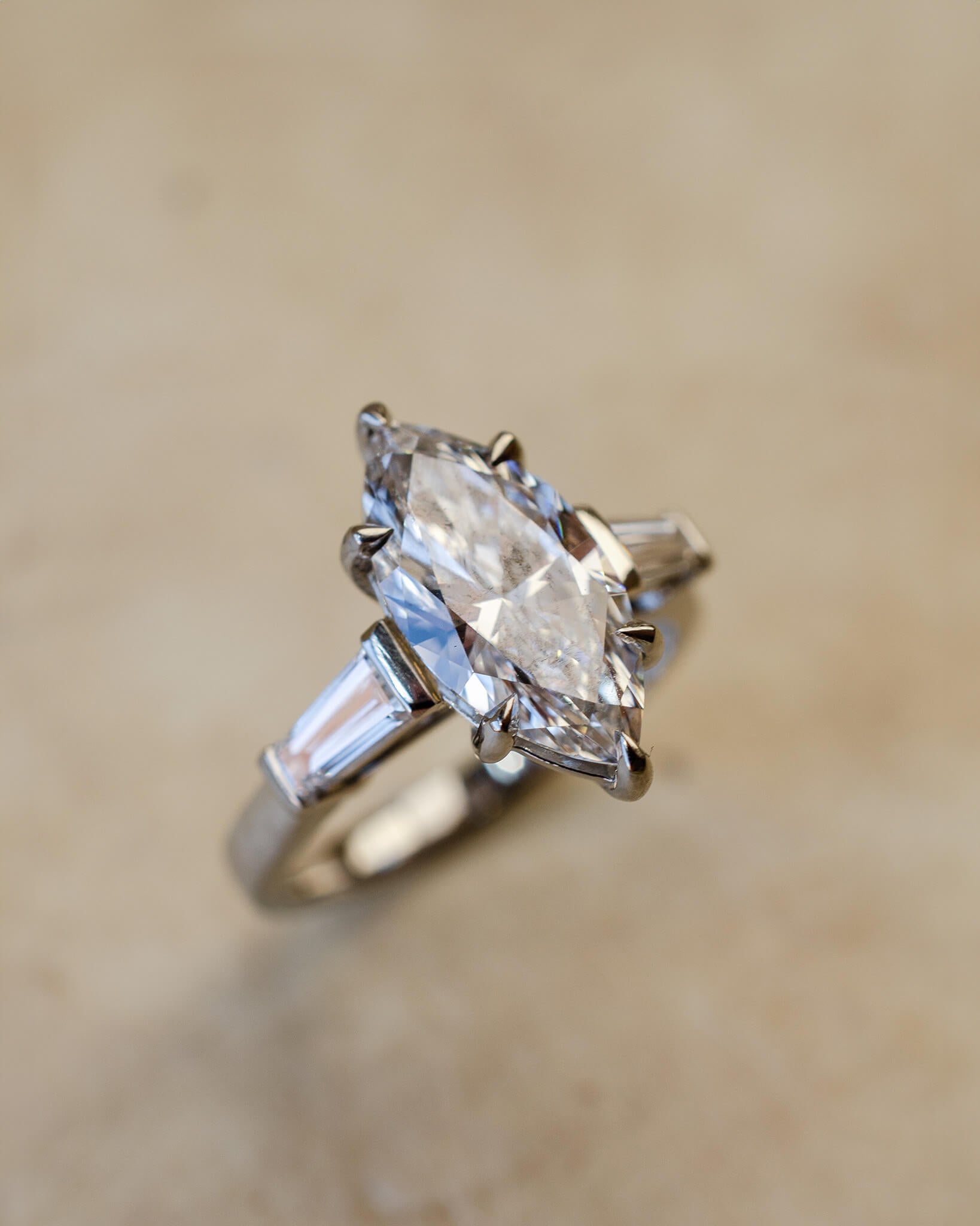 platinum diamond engagement ring with marquise and tapered baguettes