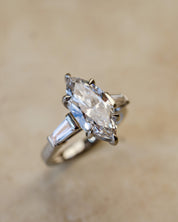 platinum diamond engagement ring with marquise and tapered baguettes