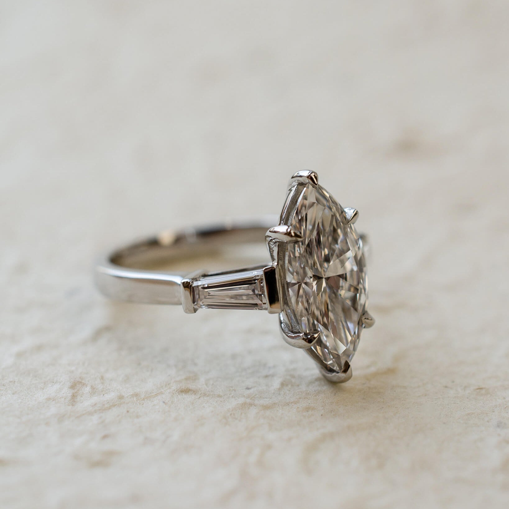 platinum diamond engagement ring with marquise and tapered baguettes