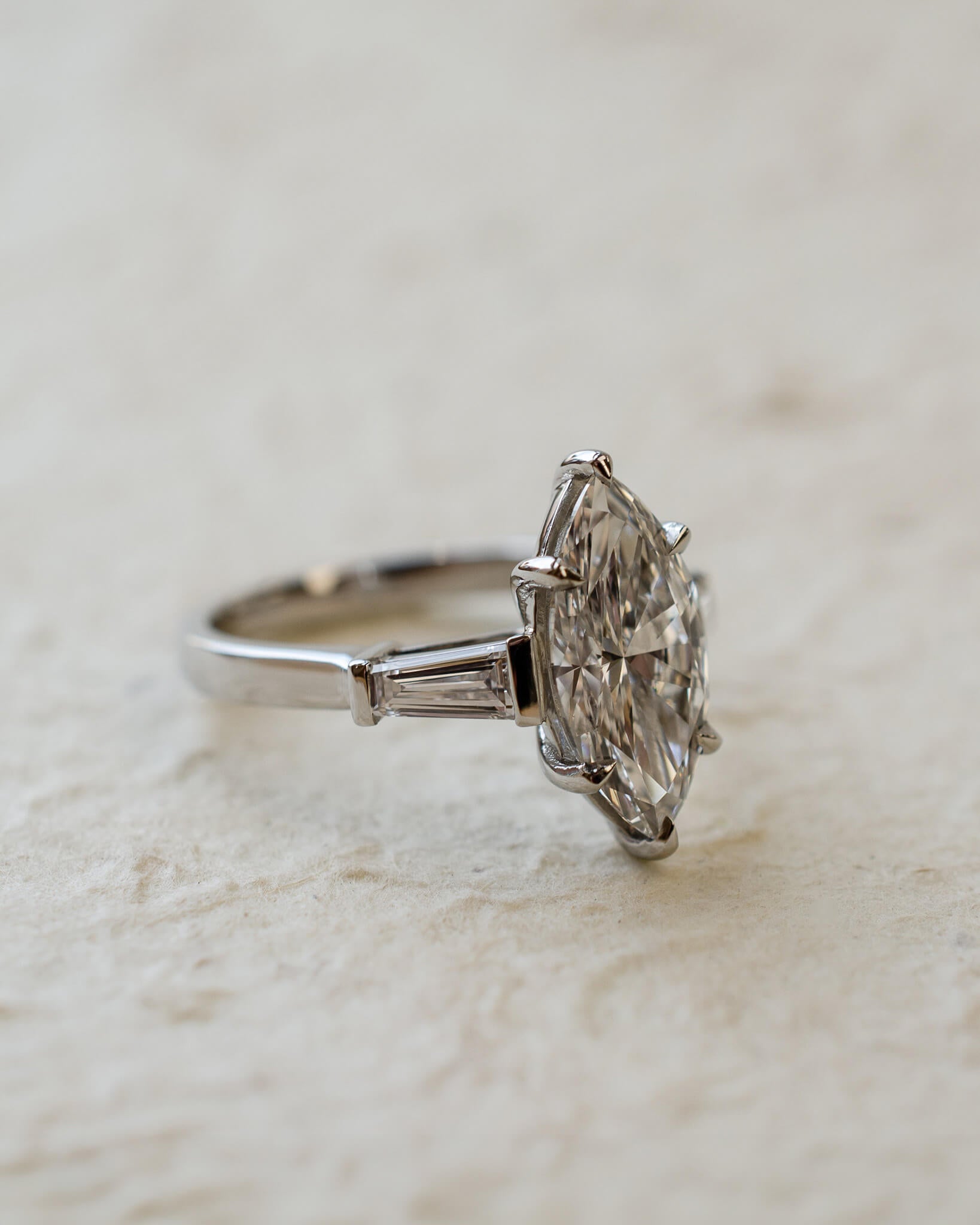 platinum diamond engagement ring with marquise and tapered baguettes