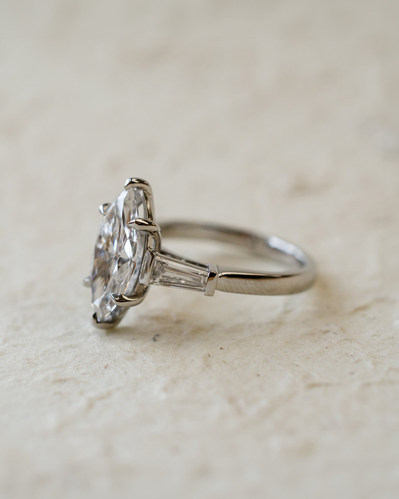 platinum diamond engagement ring with marquise and tapered baguettes