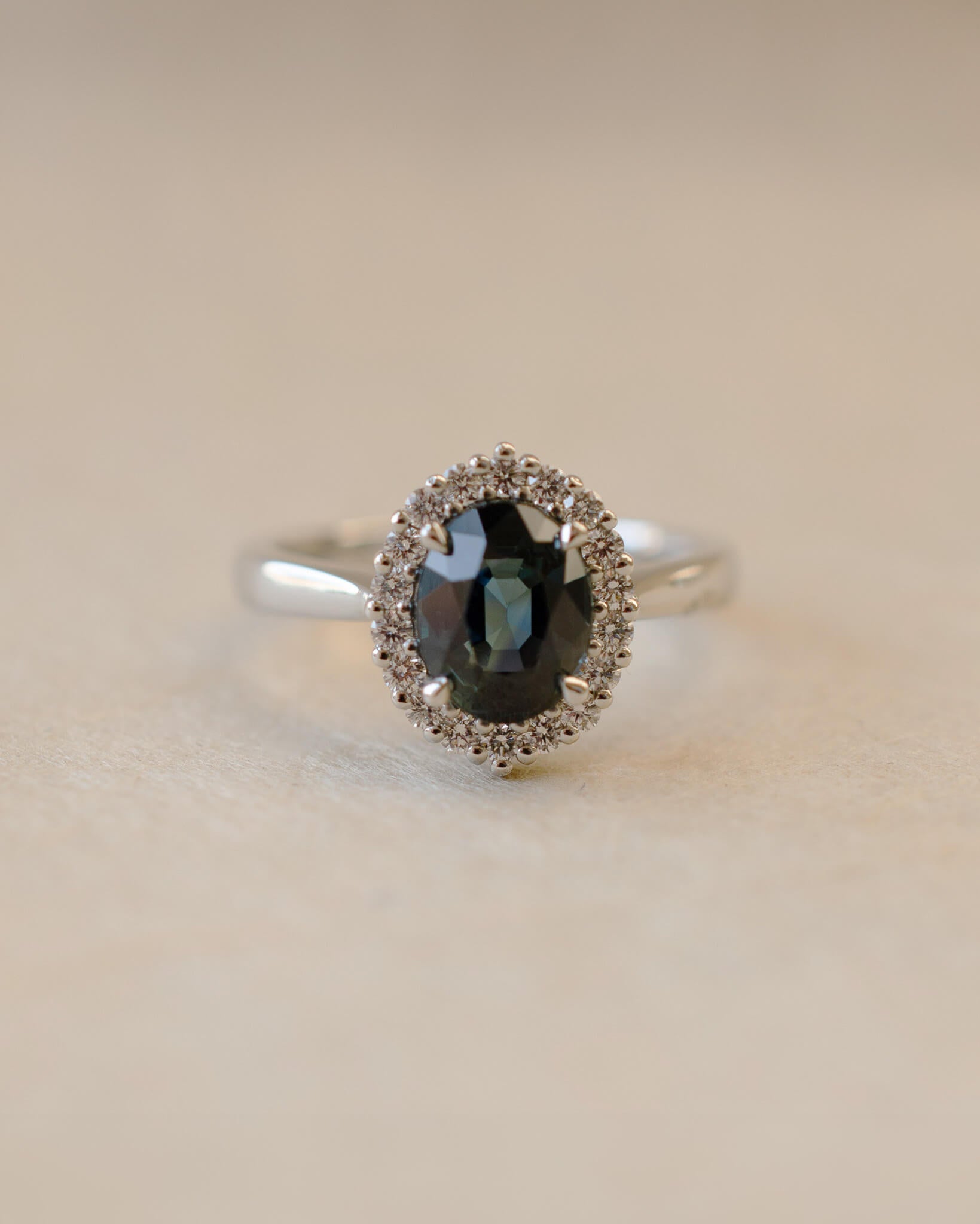 Teal sapphire and diamond cluster style ring
