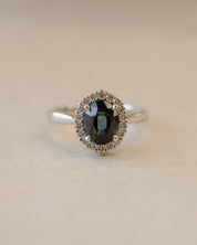 Teal sapphire and diamond cluster style ring