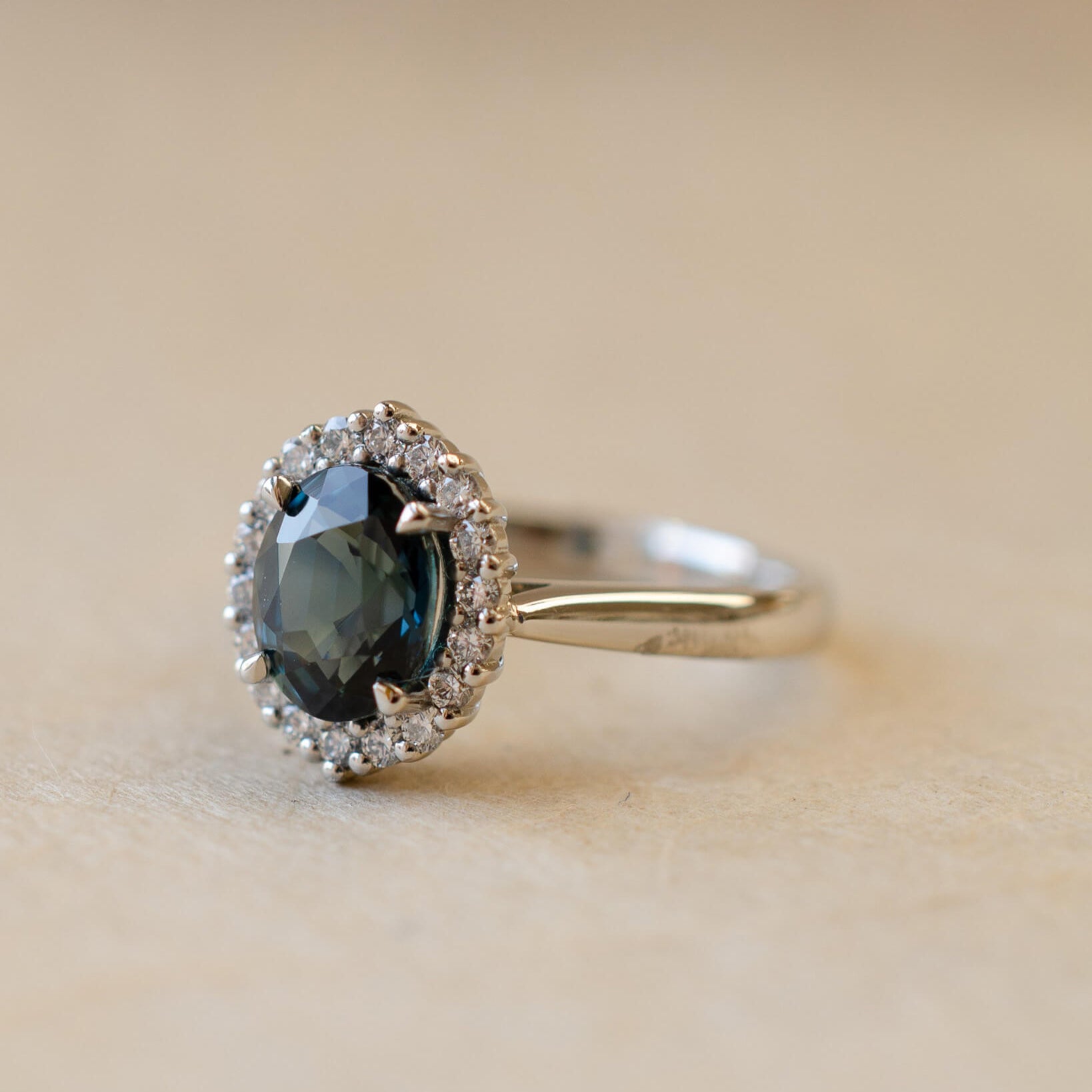 Teal sapphire and diamond cluster style ring
