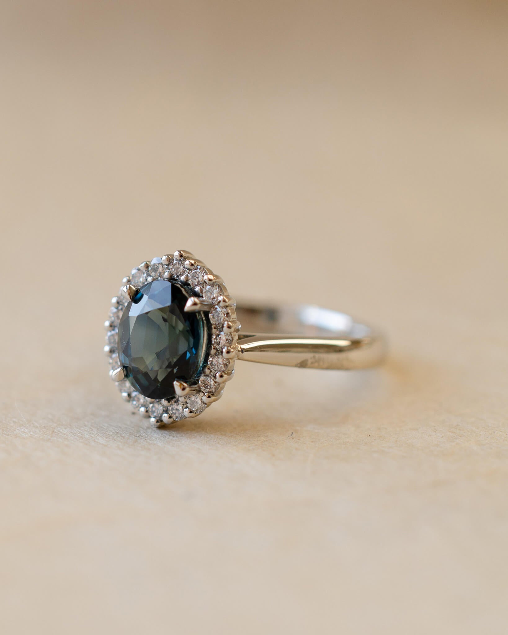 Teal sapphire and diamond cluster style ring