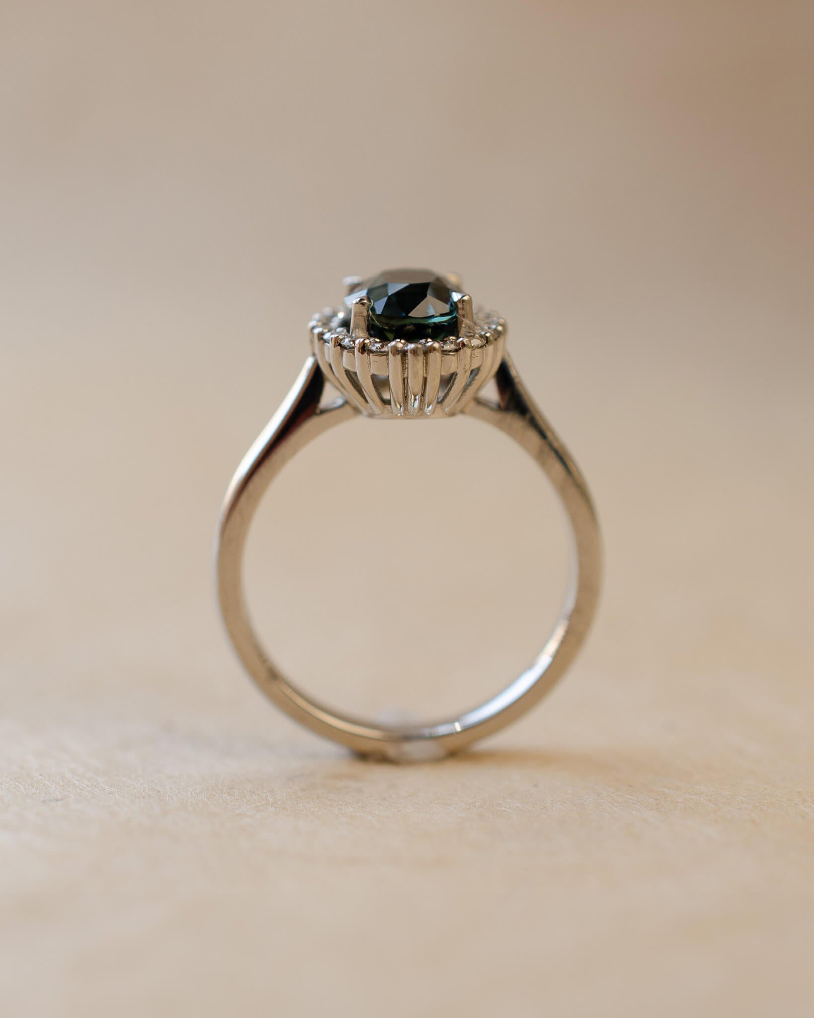Teal sapphire and diamond cluster style ring