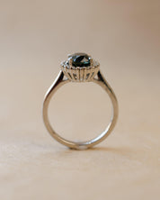 Teal sapphire and diamond cluster style ring