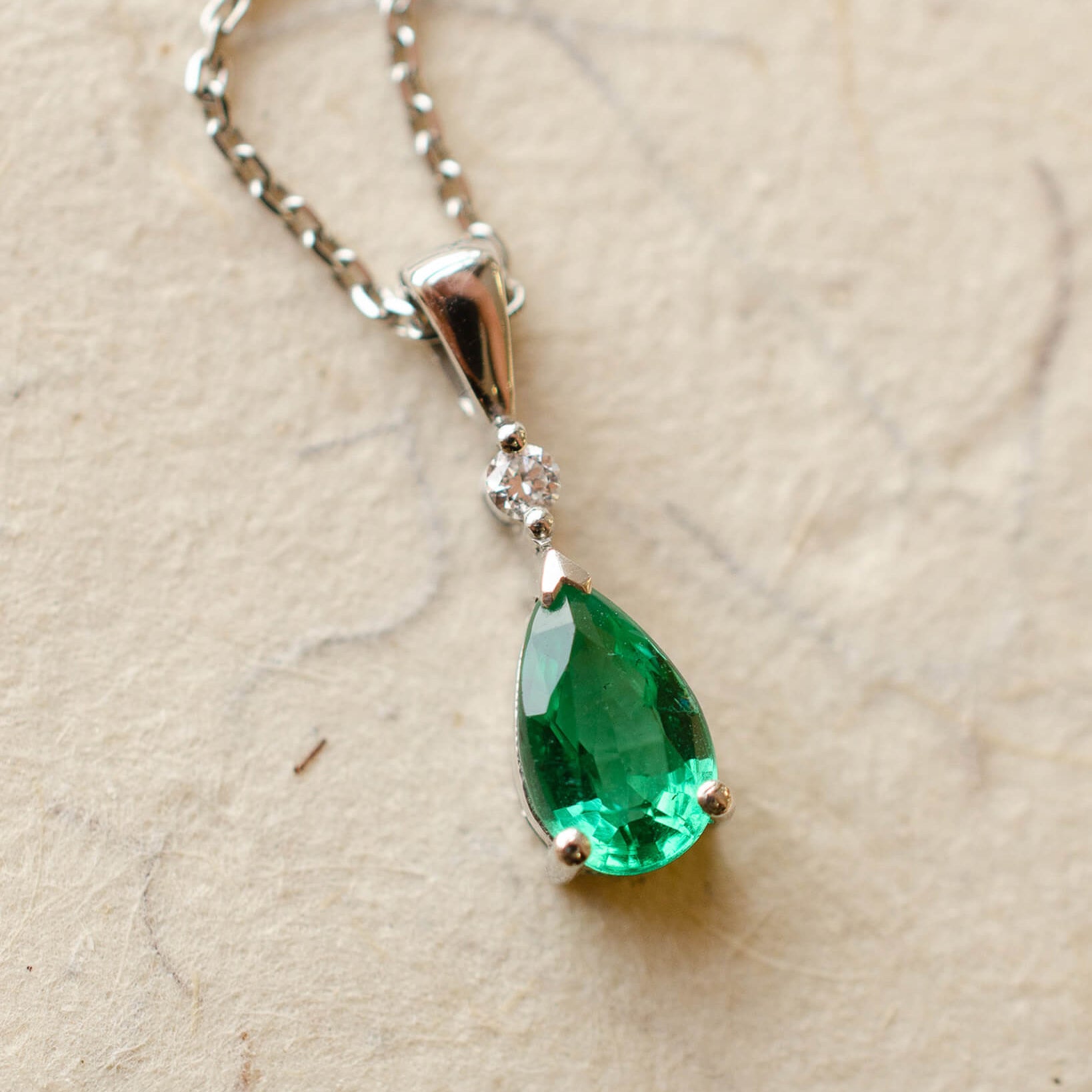Platinum diamond and pear cut emerald necklace