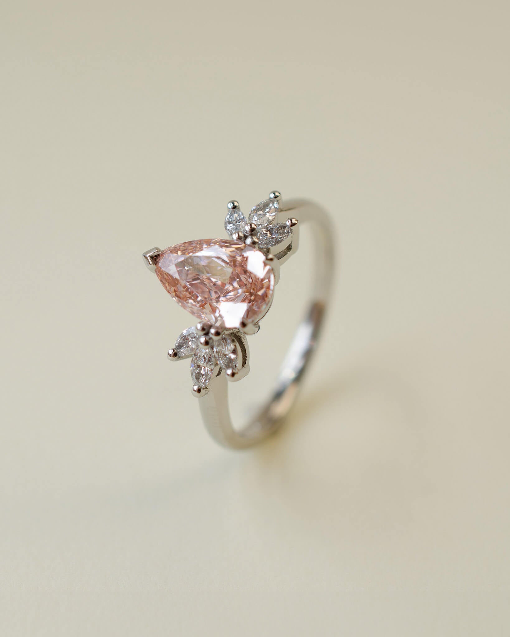 Pink pear cut lab-grown diamond ring with marquise diamond side stones