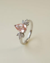 Pink pear cut lab-grown diamond ring with marquise diamond side stones