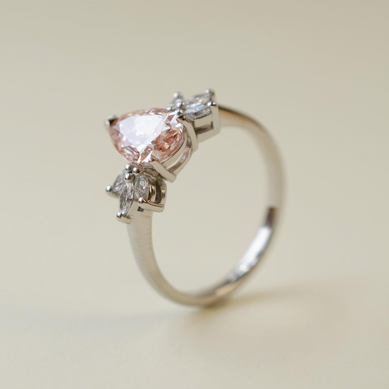 Pink pear cut lab-grown diamond ring with marquise diamond side stones