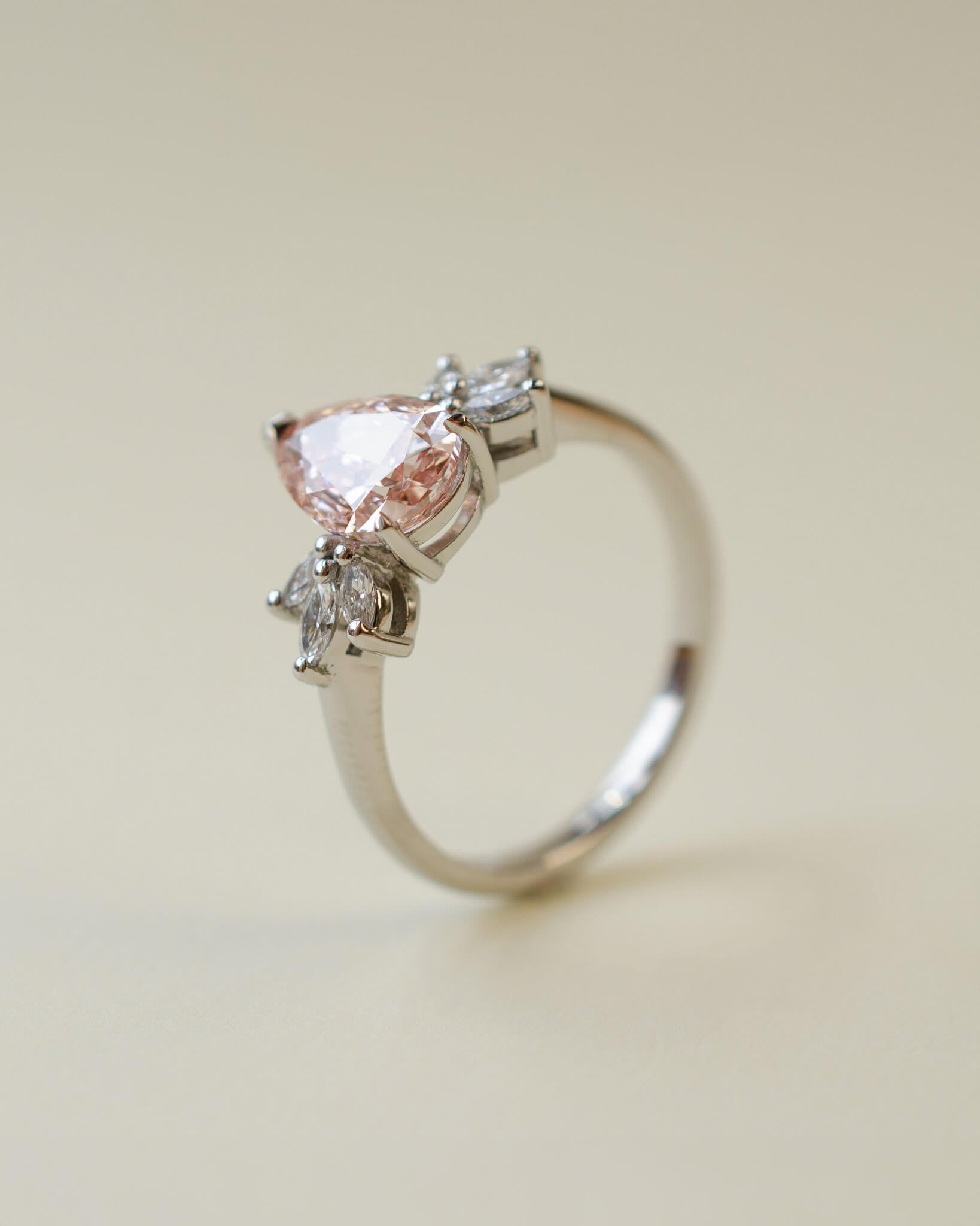 Pink pear cut lab-grown diamond ring with marquise diamond side stones